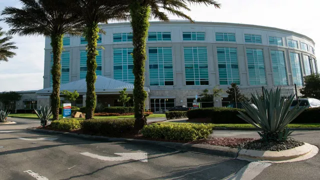 Hospital exterior with curved glass facade.