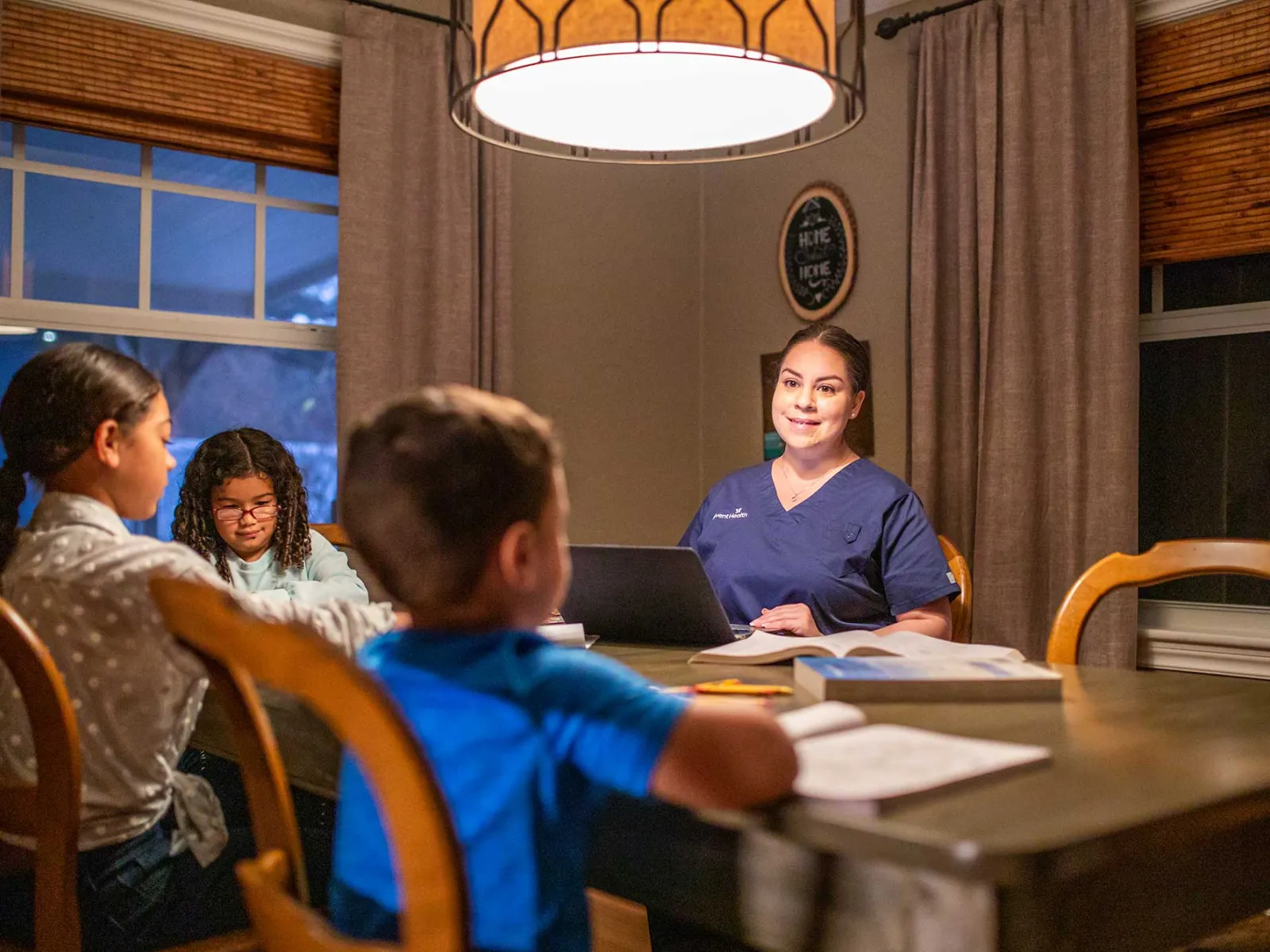 An AdventHealth employee, who's a mother, with her children at home