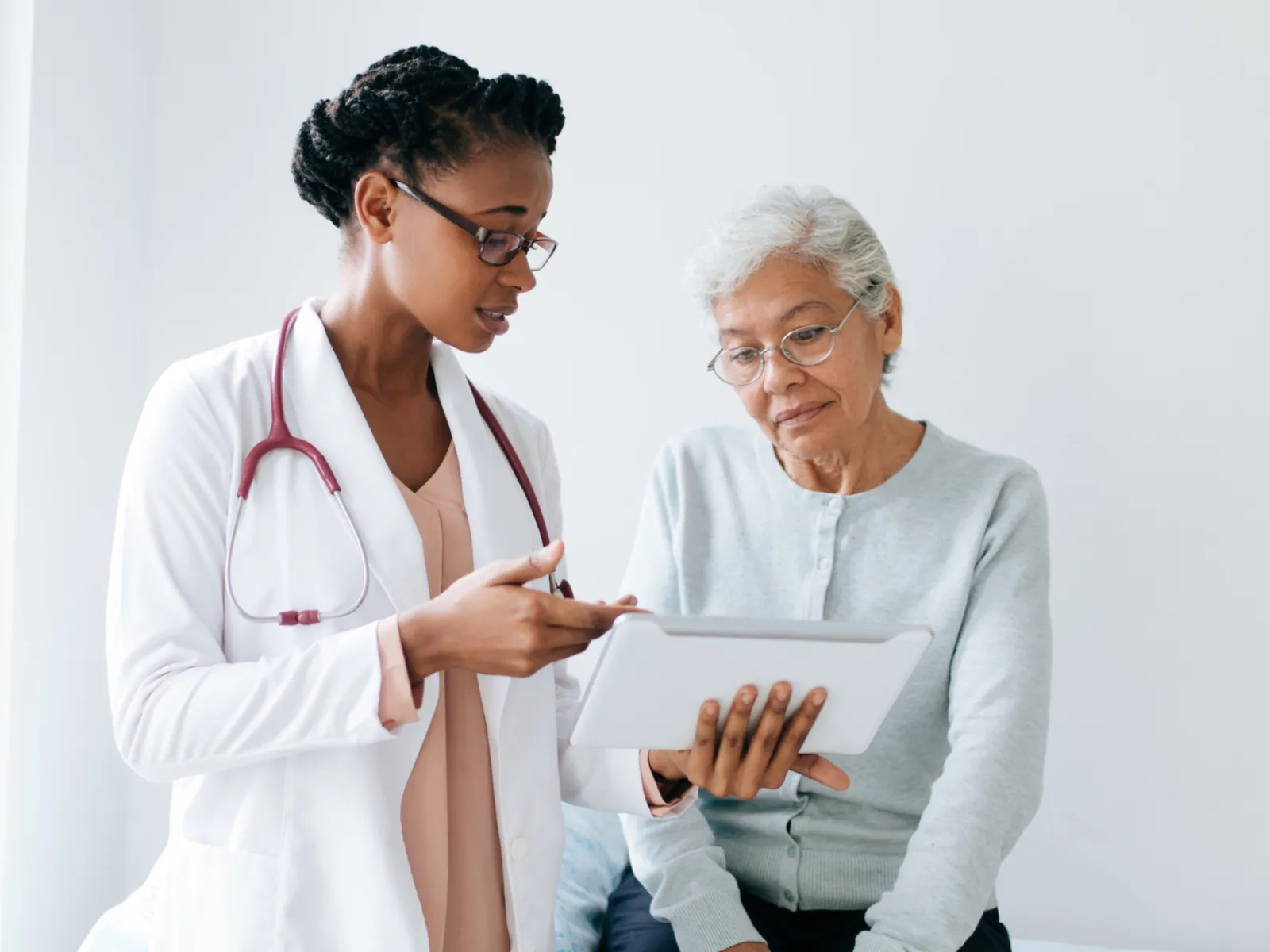 Doctor explaining to an older woman patient her test results.