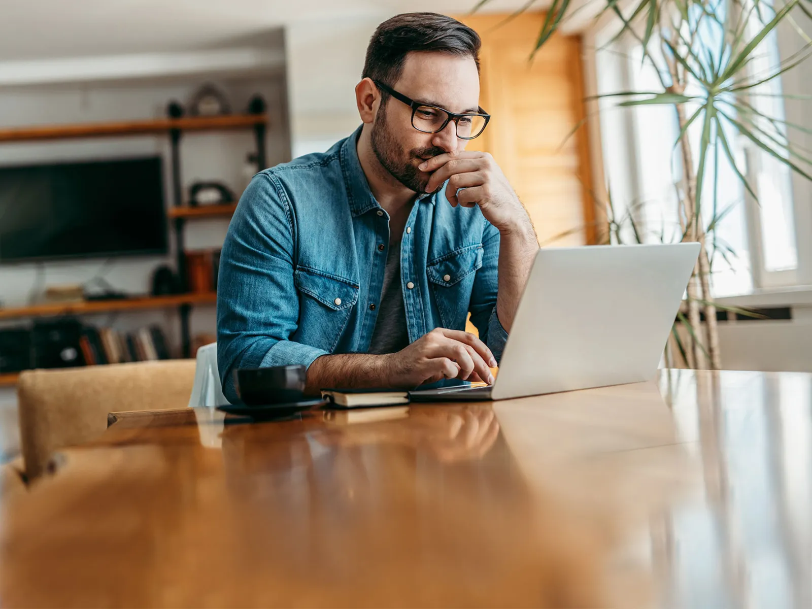A man doing research on a laptop.