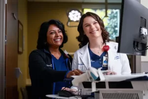 Nurse and doctor at a computer monitor
