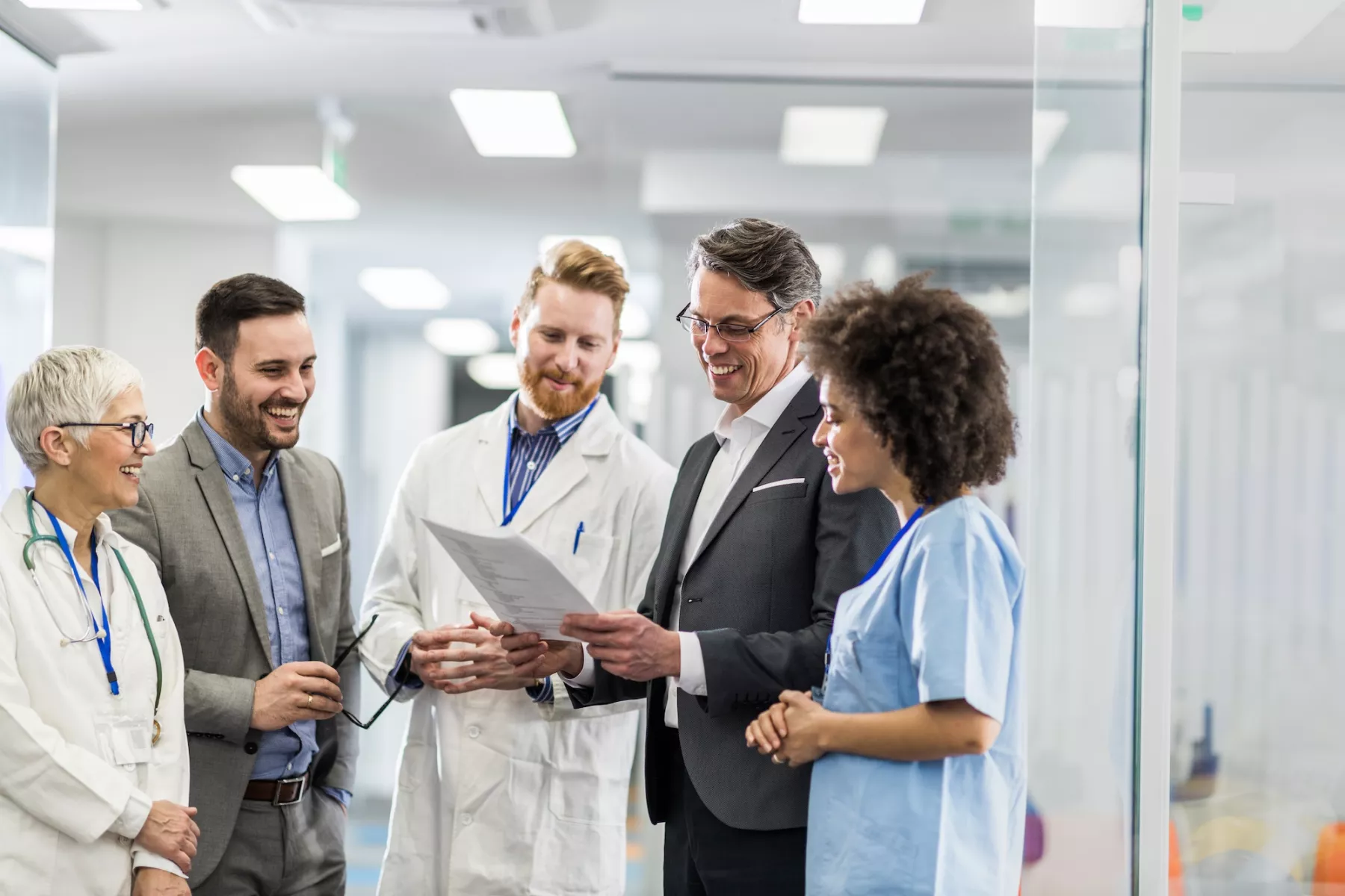 Physicians smiling and talking in hospital hallway