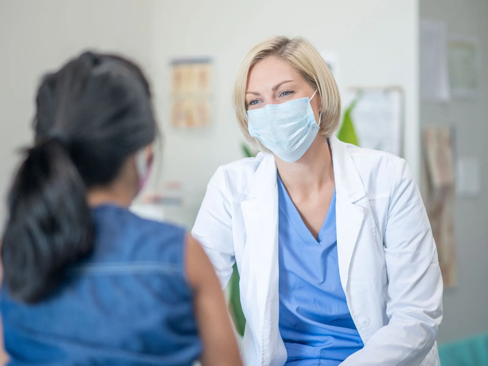 A Doctor Speaks to a Patient in the Practice Lobby