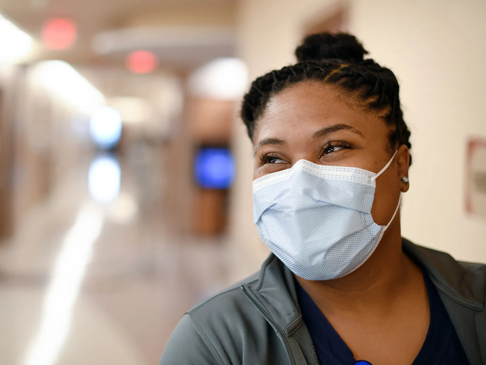 An AdventHealth nurse expressing happiness beneath her face mask
