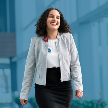 A smiling female business professional walking outside