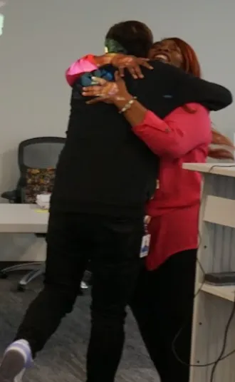 Linda Casimir hugging a TAP graduate