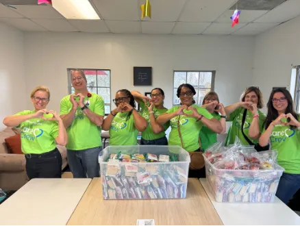 AdventHealth care crew posing with completed fresh produce packages prepared for families during the holidays